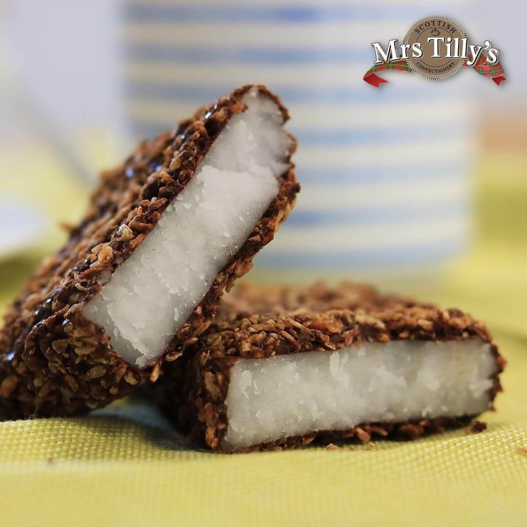 Mrs Tilly's Scottish Macaroon Bar – a delightful treat featuring a soft, sweet fondant center enrobed in rich chocolate and coated with crisp toasted coconut. This traditional Scottish confection is gluten-free and crafted with high-quality ingredients for an irresistibly indulgent experience.
