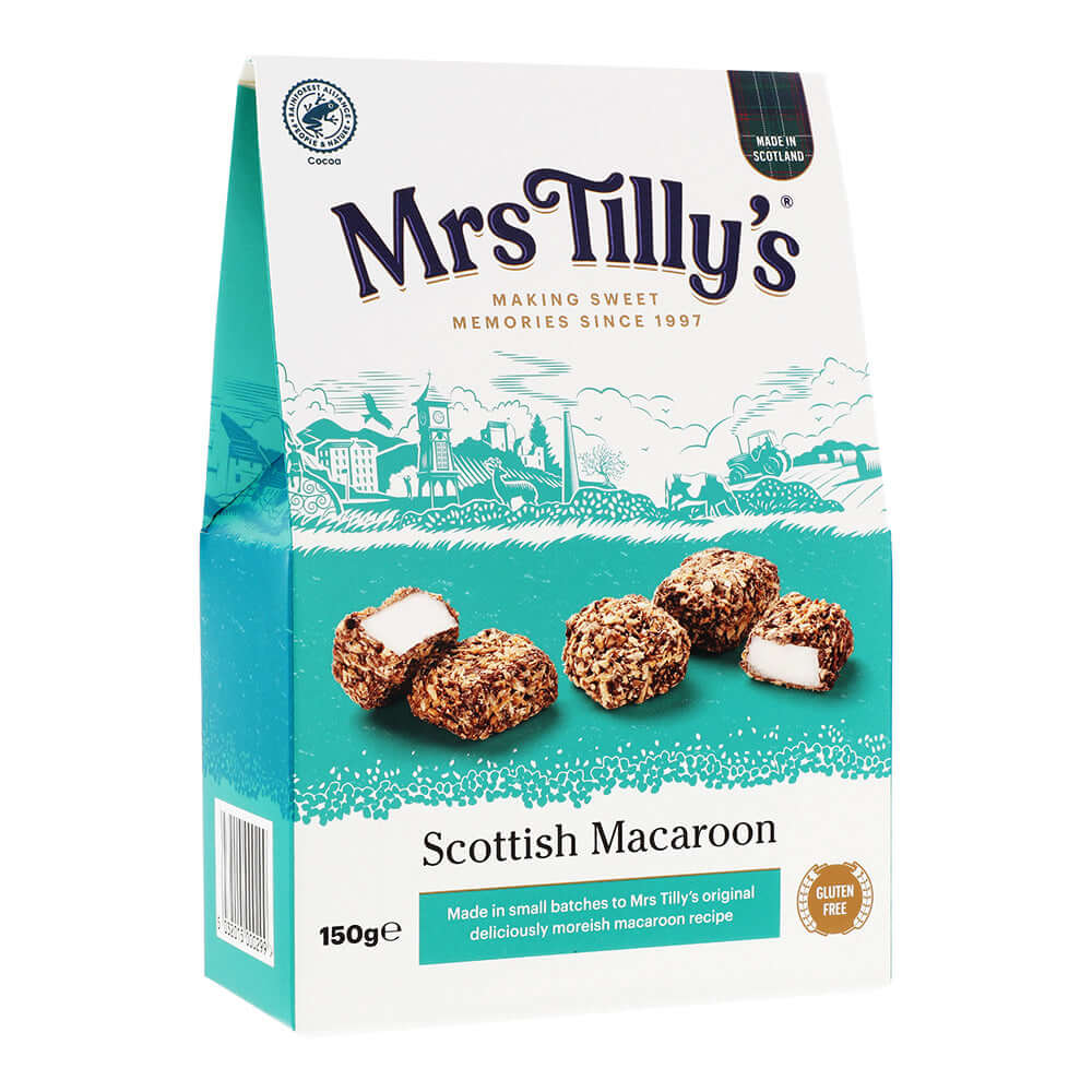 Mrs Tilly's Scottish Macaroon Gift Box – a 150g pack featuring delicious, handcrafted macaroons with a crisp toasted coconut coating and a sweet fondant center. The packaging showcases a charming Scottish village illustration, highlighting its traditional recipe and gluten-free ingredients.